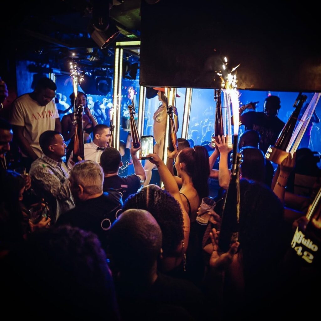 Partygoers enjoying bottle service at Tape London